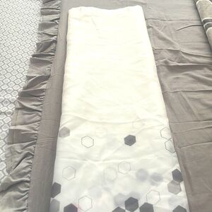 Shower curtain with grey and pink design.